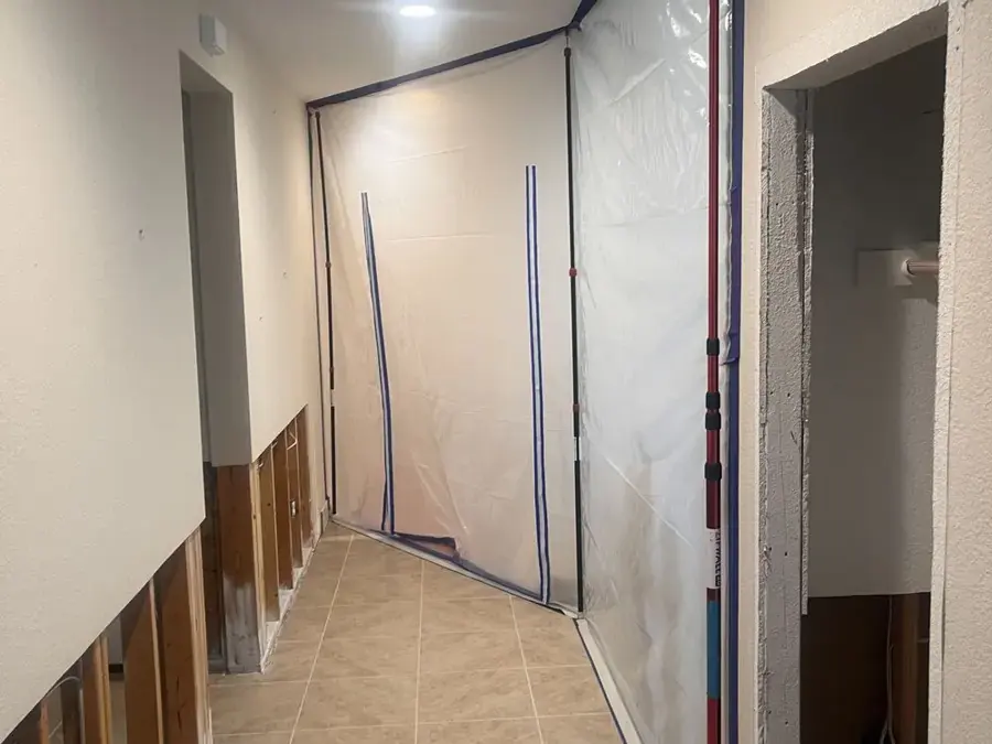 Plastic containment sealing off a hallway during a Modesto water damage dry-out