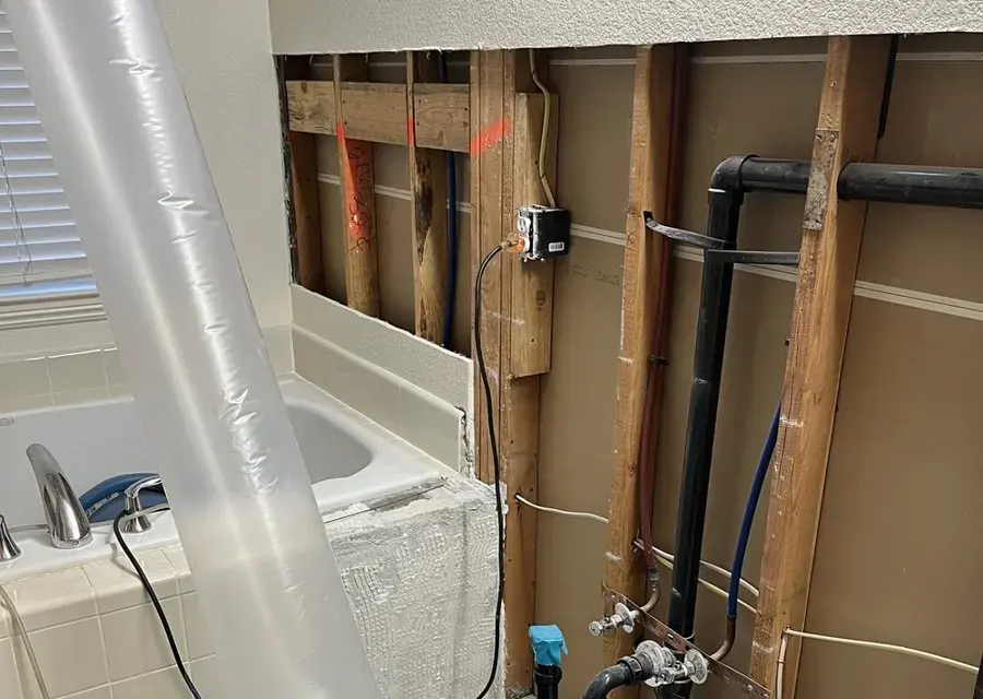 Bathroom wall opened with lay-flat ducting drying the cavity in a Modesto home