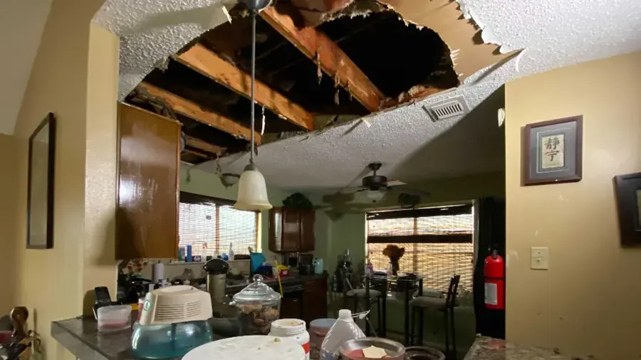 Collapsed ceiling drywall above a kitchen after a water leak in Modesto