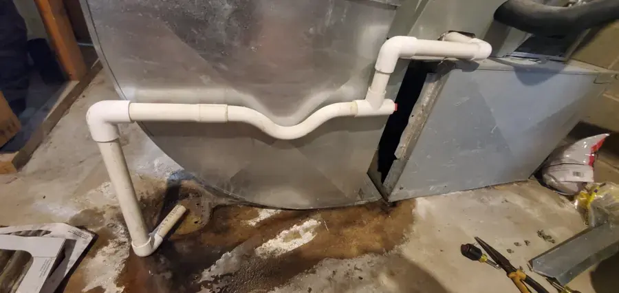Air handler with condensate lines and pooled water on the floor in Modesto