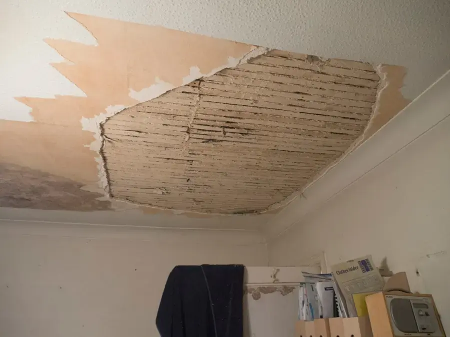 Plaster ceiling sagging after a roof leak in an older Modesto home