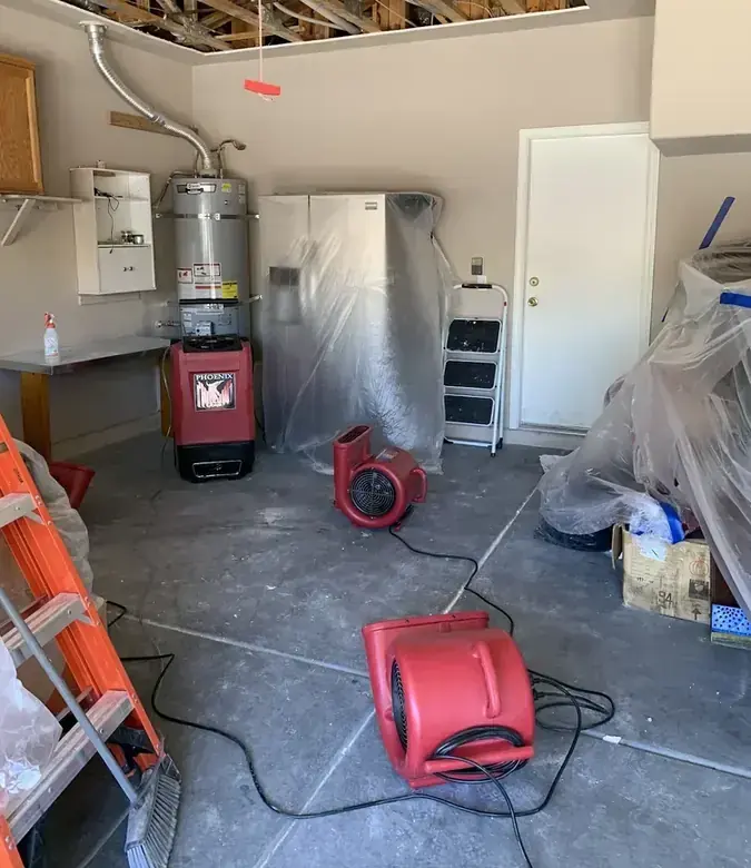 Garage water heater with drying equipment running after a leak in Modesto